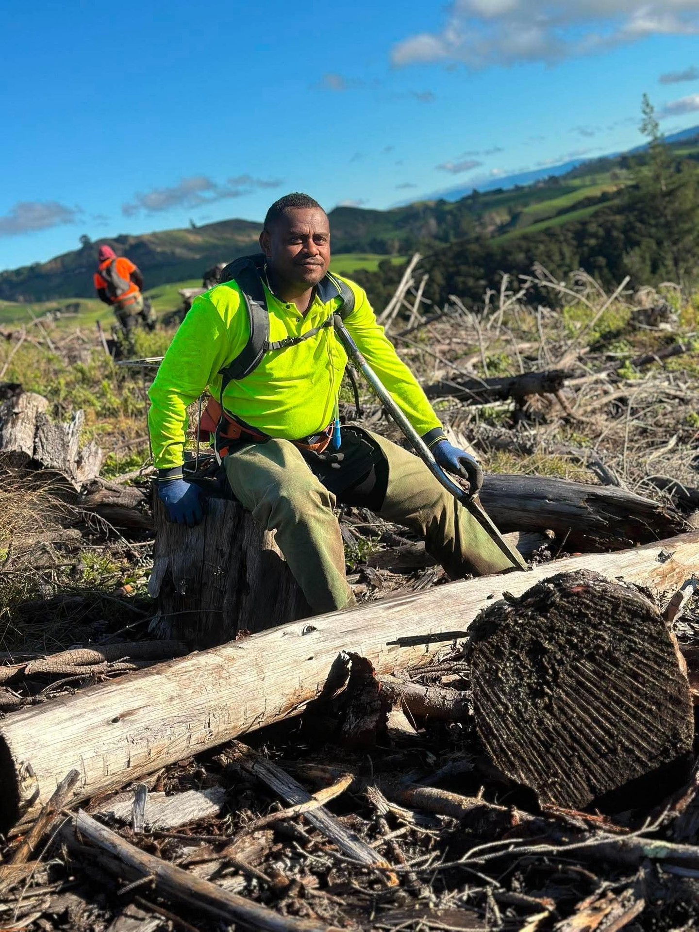Chainsaw operator on a felled log