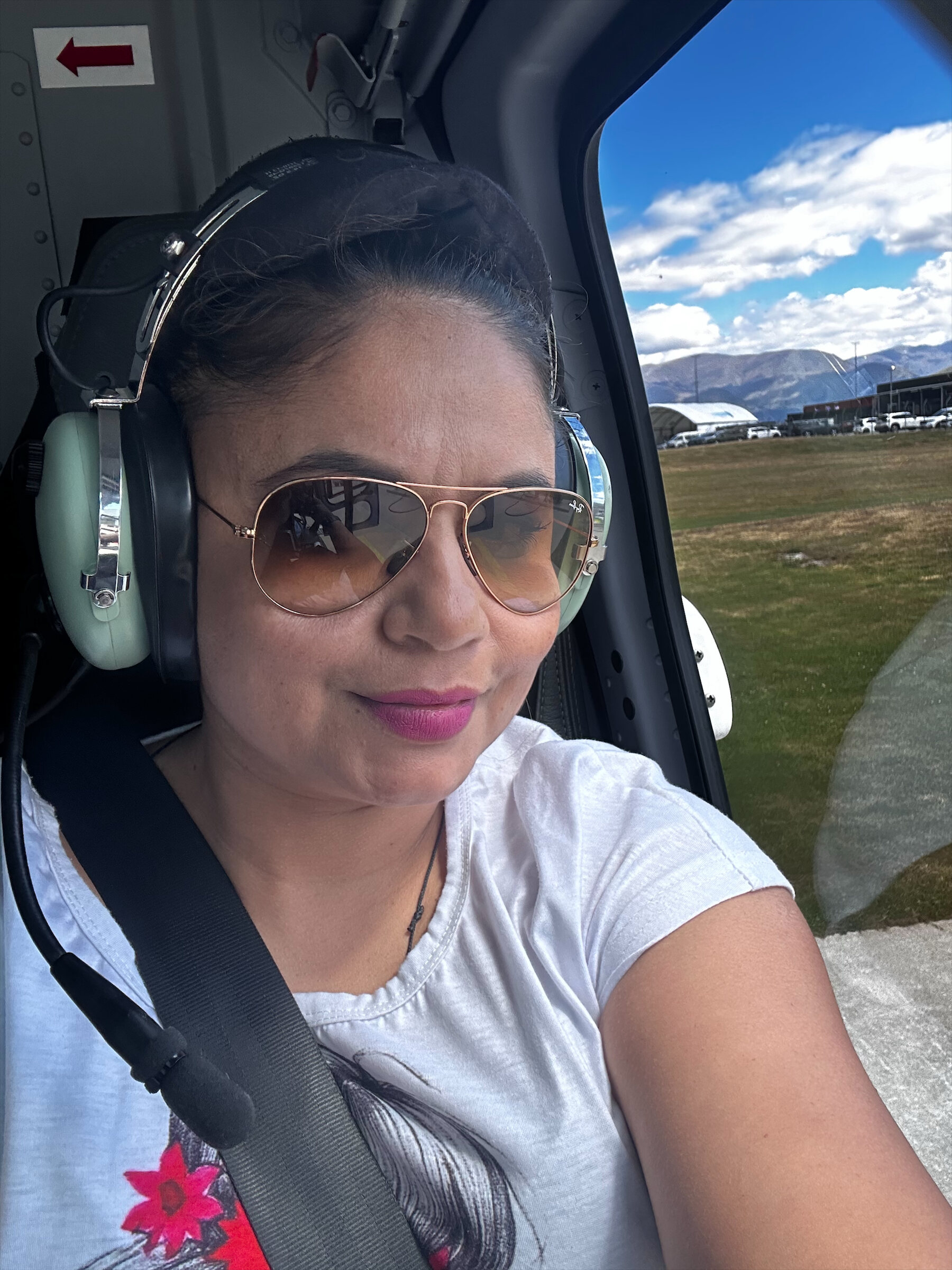 Taziana (Taz), director of FM Silvi Limited, in a helicopter headset